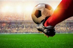 red-soccer-player-kicking-ball-action-stadium